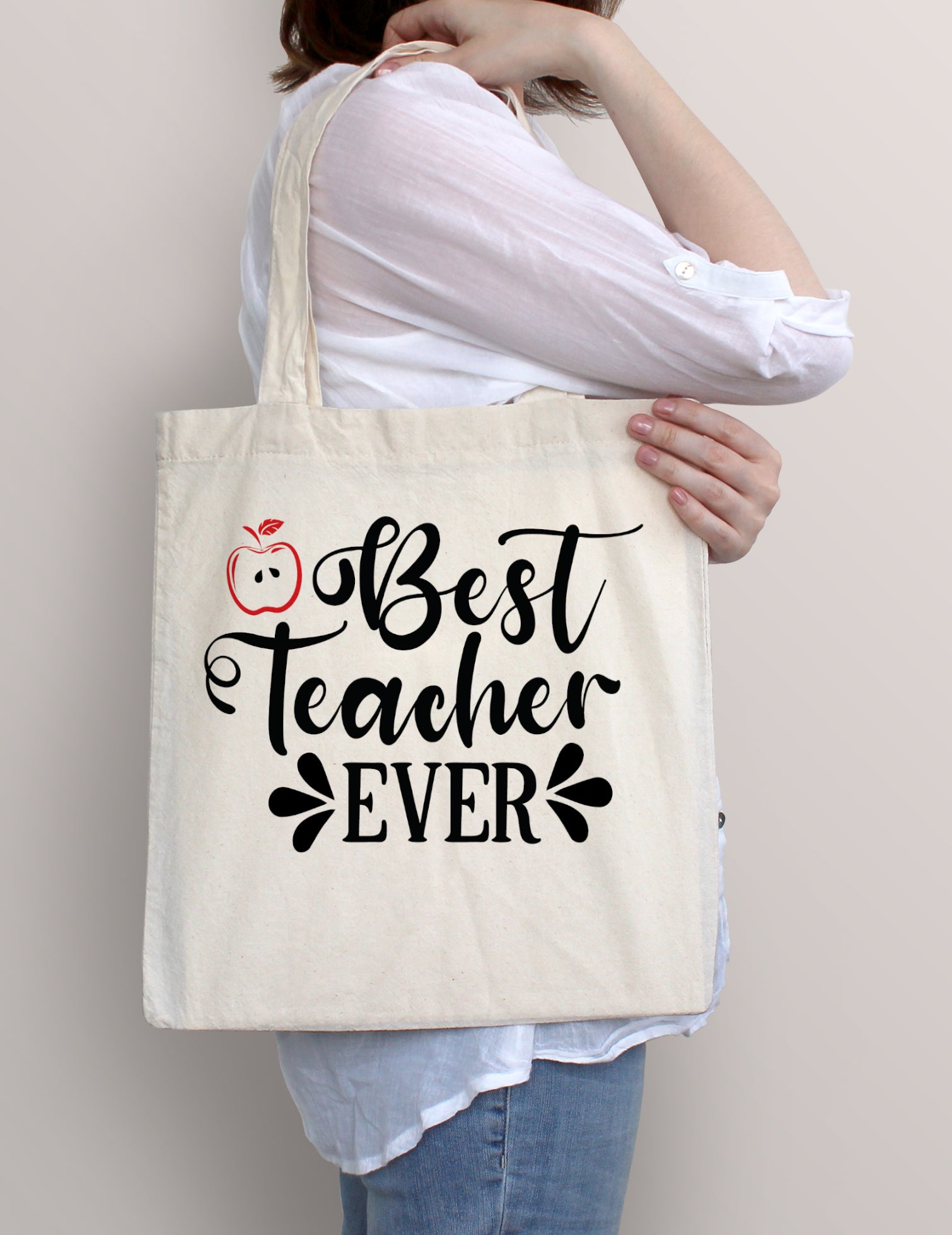 Woman carrying Best Teacher Ever cotton tote bag