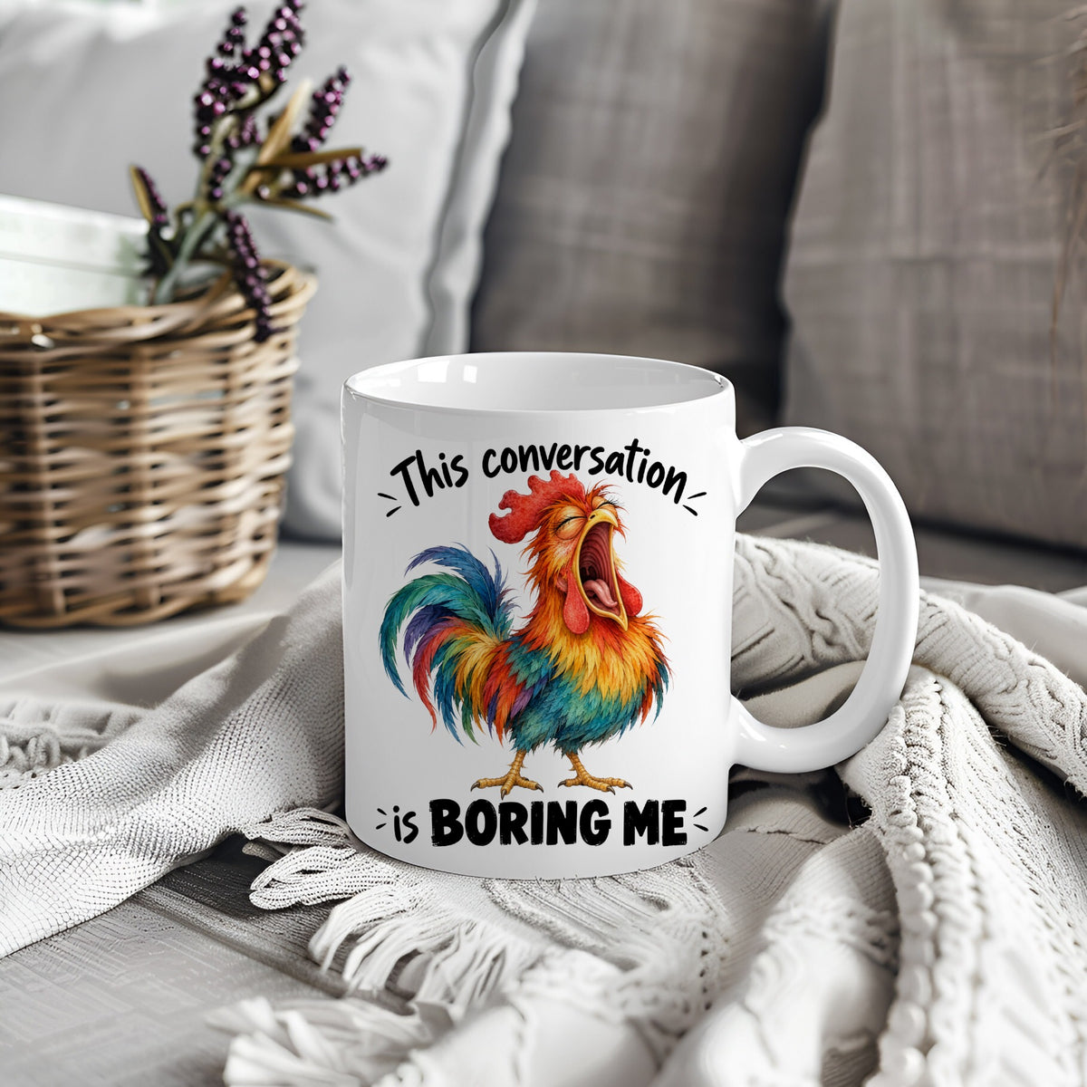White mug with colourful rooster design and text This Conversation Is Boring Me