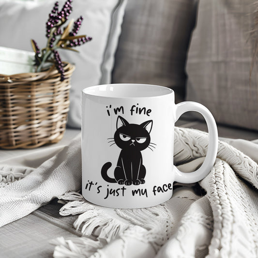 White mug with black cat design and text I'm Fine It's Just My Face