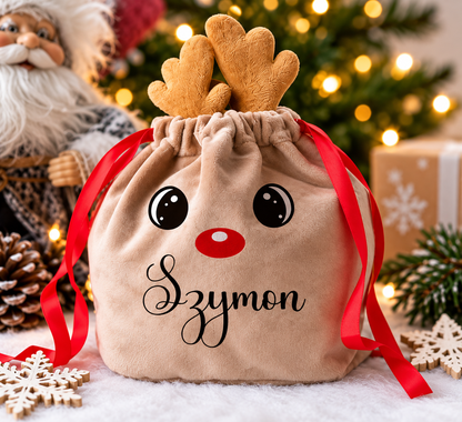 Personalised Christmas reindeer gift bag with brown antlers, red ribbon and Szymon name