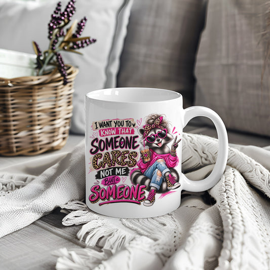 White mug with raccoon design and text I Want You To Know That Someone Cares Not Me But Someone