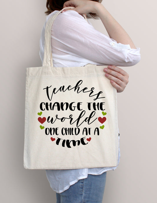 Woman carrying Teachers Change the World One Child at a Time cotton tote bag